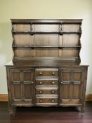 An Ercol stained elm dresser, 145 cm x 52 cm x 168 cm.