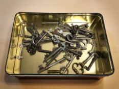 A tin of antique keys.