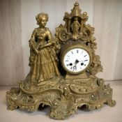 A 19th century gilt metal figural eight day mantel clock, height 36 cm.
