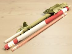 Three rolls of upholstery material.