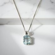 A 9ct white gold blue topaz pendant on chain CONDITION REPORT: 3.