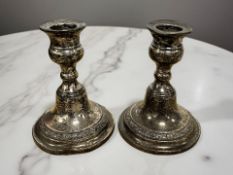 A pair of loaded-silver dwarf candlesticks, Birmingham 1956, height 12cm.