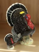 A Beswick turkey 1957, bronze gloss, height 18 cm, together with a similar smaller figure.