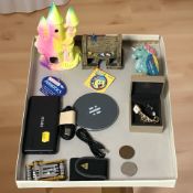 Miscellaneous items including a power bank, a cordless charger, a multi tool,