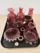 A group of cranberry glass items.