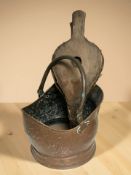 A Victorian copper coal helmet and a pair of fire bellows.