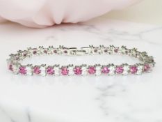 A silver and ruby line bracelet,