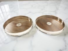 A pair of Elizabeth II silver and mahogany bottle coasters, Birmingham 1988, diameter 15cm.