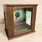 A glazed mahogany table top cabinet with later clock blade advertising, height 36 cm.