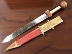 A copy of a Roman gladius, with 48 cm double edged blade, faux ivory and wooden grip,