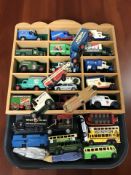 A wooden display stand and a quantity of Lledo die cast delivery vans, buses, etc.