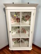 A painted and glazed hanging corner cabinet, height 100 cm.