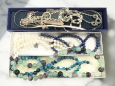 A group of silver necklaces,