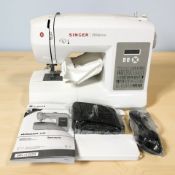 A Singer Brilliance digital sewing machine, with lead, pedal and instructions.