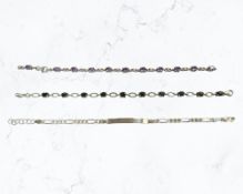 A silver identity bracelet, an amethyst bracelet,