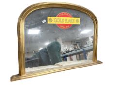 A modern gilt overmantel mirror with Wills golden flake decoration, width 120 cm.