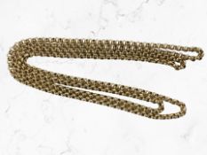 A long gold plated muff chain, approximately 152 cm length.