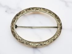 A yellow metal antique oval brooch,
