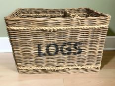 A large wicker two-division log basket, width 83 cm.