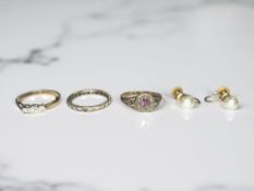 A three stone diamond ring, a paste eternity ring, a 19th century cluster ring,