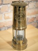 An E Thomas & Williams Ltd brass miner's lamp.