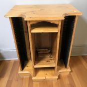 A contemporary pine entertainment unit with CD shelves, width 61 cm.