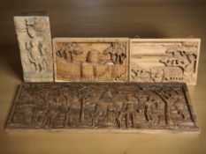 A group of eastern carved relief wooden panels, largest 74 cm x 26 cm.