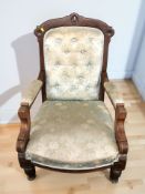 A Victorian library armchair in deep buttoned satin upholstery.