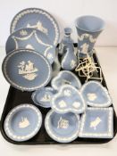A collection of Wedgwood blue and white jasperware to include plates and shallow dishes, vases, etc.