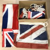 A 150 cm x 83 cm Union flag, three smaller flags and four Union flag shoulder bags.