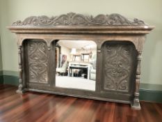 A Victorian carved and stained oak overmantel mirror,