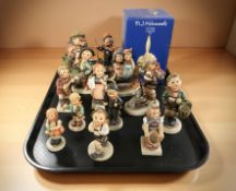 Thirteen Goebel figurines of boys and girls and a further bell in box.