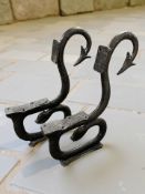 A pair of painted cast iron bench ends with forked tail terminals, height 87 cm.
