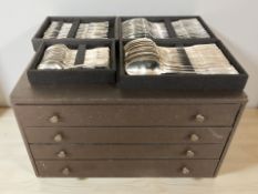 A four drawer cutlery chest containing a French EPNS service of cutlery.