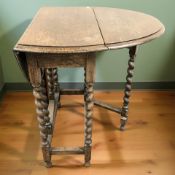 An Edwardian oak barley twist gate leg table