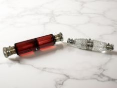 An antique ruby glass double-ended scent bottle with unmarked white metal caps, length 15cm,