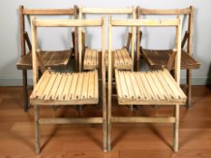 Five folding wooden chairs