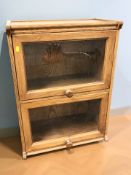 A reproduction glazed oak two door bookcase, 59 cm x 33 cm x 80 cm.