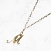 A 9ct gold letter M pendant on 9ct gold chain CONDITION REPORT: 2g