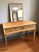 A 20th century three drawer dressing table with mirror back, 107 cm wide.