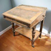 A Victorian oak and walnut sloped writing desk with inset presentation plaque dated 1885,
