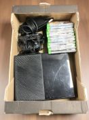 An Xbox One with leads, controllers, several games.