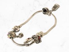 A white metal charm bracelet signed Pandora, stamped 925.