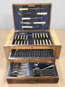 An oak canteen of EPNS cutlery.