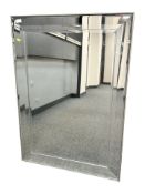 A contemporary bevelled mirror, 76 cm x 107 cm.