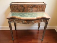 A reproduction inlaid mahogany serpentine front lady's desk in the Edwardian style,