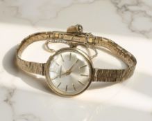 A lady's 9ct gold Garrard wristwatch on 9ct gold integral bracelet CONDITION REPORT: