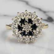 An 18ct gold sapphire and diamond cluster ring, size K CONDITION REPORT: 3.