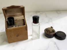 A pair of glass dressing table bottles in leather travel case, height 10.