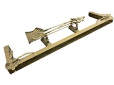 A Victorian brass fire curb, a pair of fire dogs and a companion set.